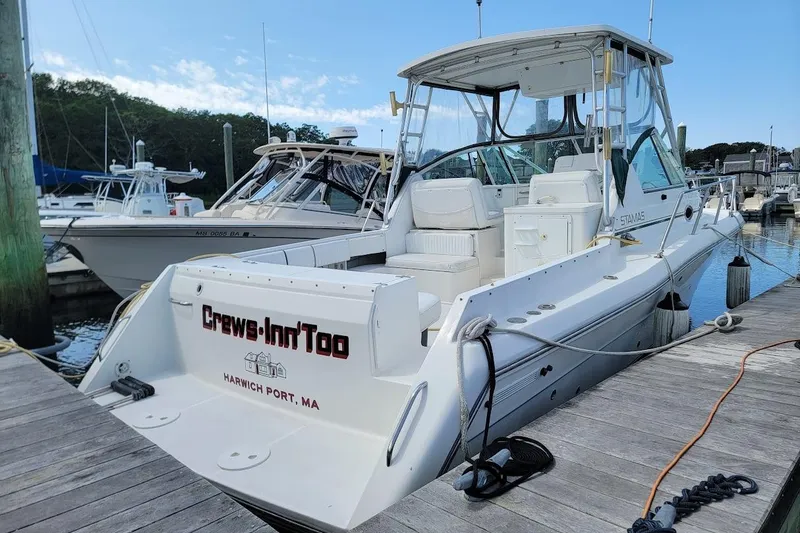 Slide: The Image of 2000 Stamas 310 Express boat docked at Harwich Port, MA, named "Crews-Inn'Too". - 28