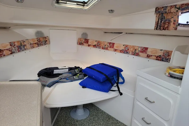 Slide: The Image of Interior cabin of 2000 Stamas 310 Express boat with life jackets on table. - 5