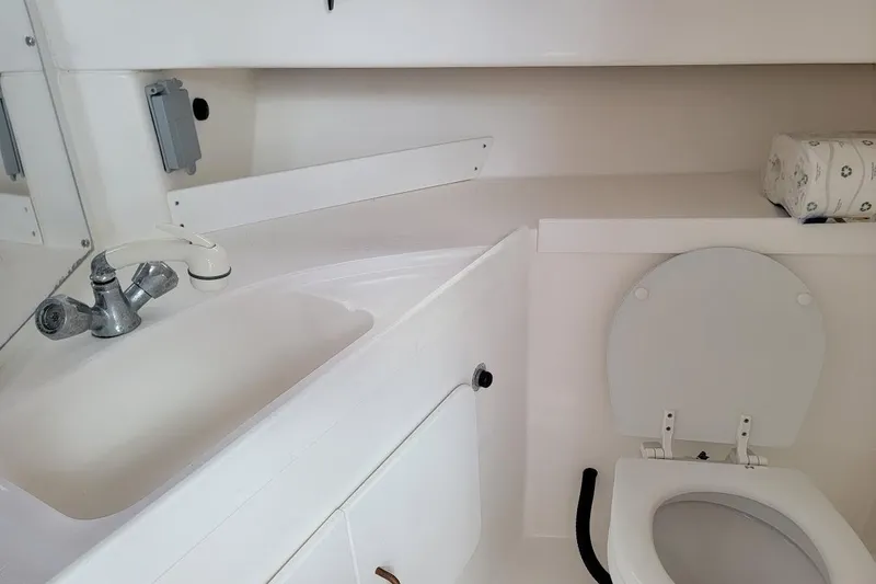Slide: The Image of 2000 Stamas 310 Express boat bathroom with sink and toilet. - 6