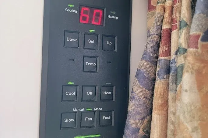 Slide: The Image of Thermostat control panel on 2000 Stamas 310 Express boat, displaying temperature settings. - 7