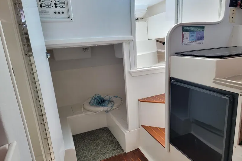 Slide: The Image of Interior of 2000 Stamas 310 Express boat with steps, storage, and control panel. - 8