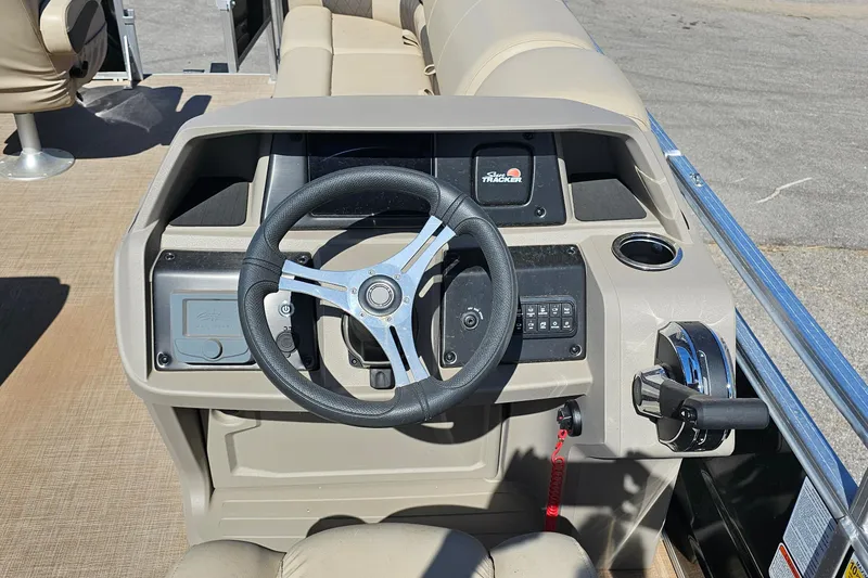 Slide: The Image of 2024 Sun Tracker SportFish 20 DLX boat console with steering wheel and controls. - 10