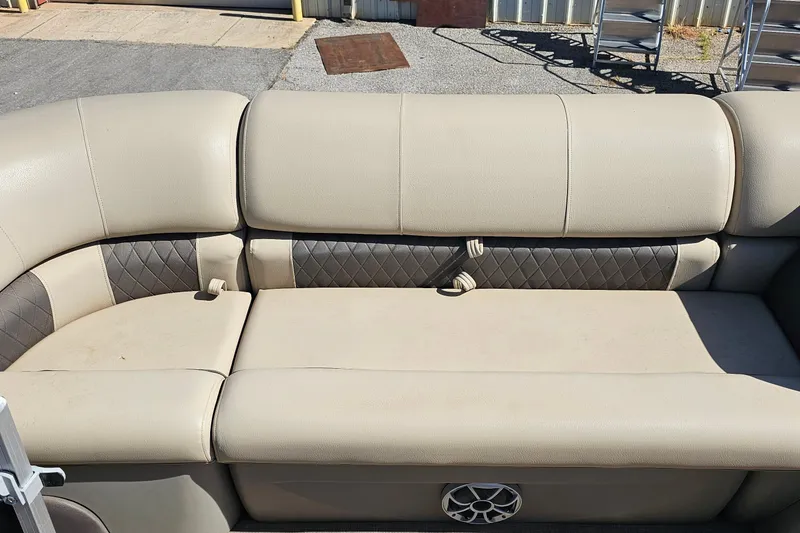 Slide: The Image of 2024 Sun Tracker SportFish 20 DLX boat seating with beige upholstery and speaker. - 11