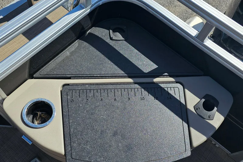 Slide: The Image of 2024 Sun Tracker SportFish 20 DLX boat deck with cup holders and measuring board. - 12