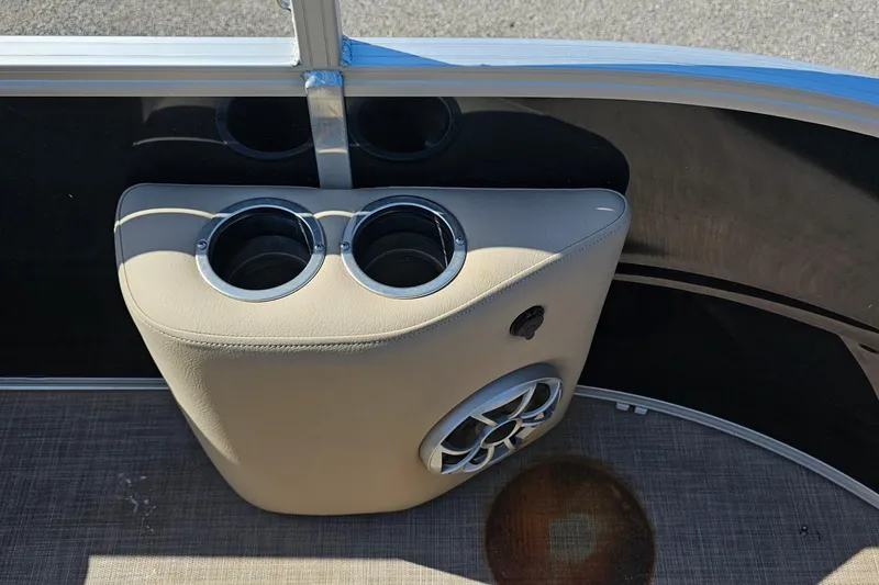 Slide: The Image of 2024 Sun Tracker SportFish 20 DLX pontoon boat on trailer outside marine shop. - 5