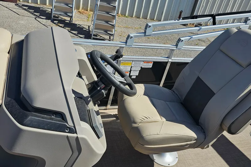 Slide: The Image of 2024 Sun Tracker SportFish 20 DLX boat interior with steering wheel and captain's chair. - 7