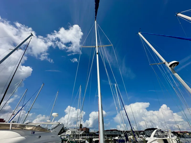 Slide: The Image of Sailboat masts against a blue sky, Catalina 36, 2005 model, marina setting. - 10