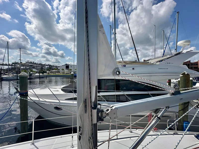Slide: The Image of 2005 Catalina 36 sailboat docked at marina under a partly cloudy sky. - 13