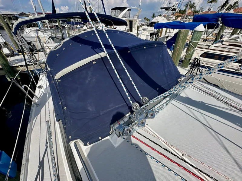 Slide: The Image of 2005 Catalina 36 sailboat with blue canvas cover docked at marina. - 16