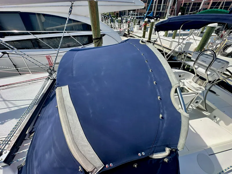 Slide: The Image of Catalina 36 sailboat, 2005 model, featuring a blue canvas cover and marina background. - 19