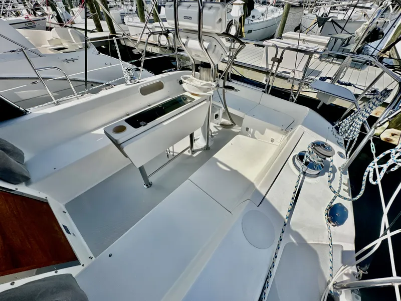 Slide: The Image of 2005 Catalina 36 sailboat cockpit with steering wheel and seating, docked at marina. - 21