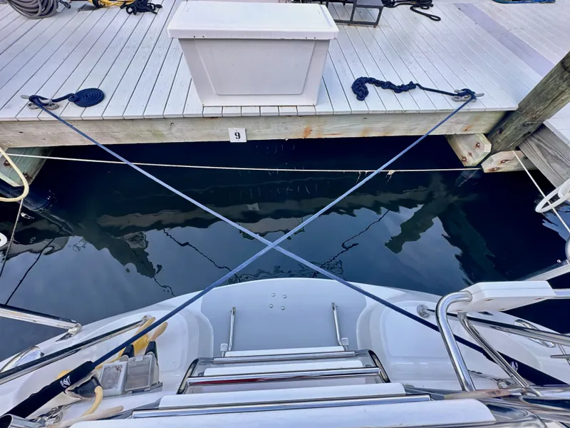 Slide: The Image of Catalina 36 sailboat docked, stern view, with ropes and dock equipment, 2005 model. - 27