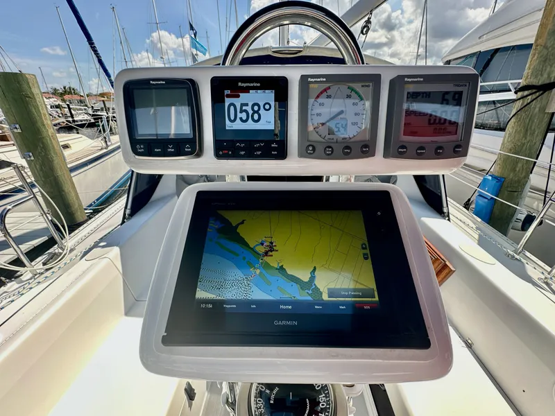 Slide: The Image of Cockpit of 2005 Catalina 36 sailboat with navigation instruments and Garmin display. - 29