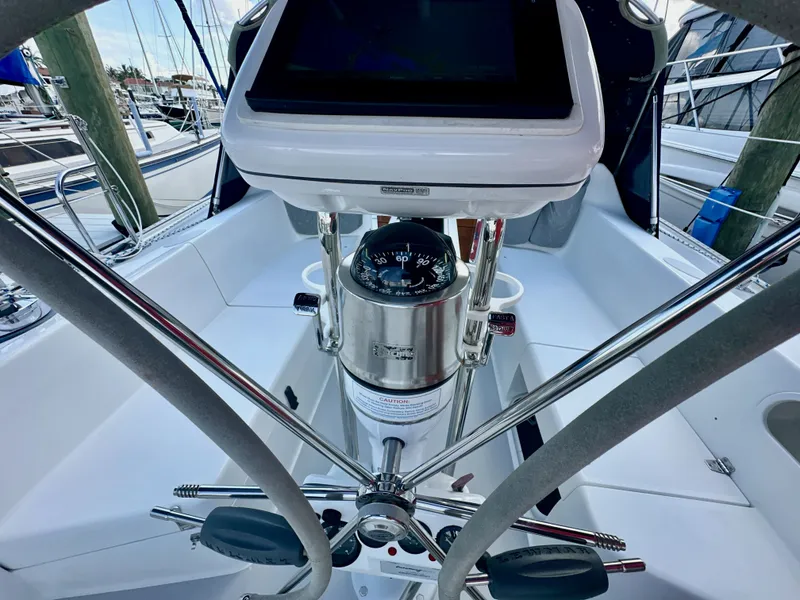 Slide: The Image of Cockpit view of a 2005 Catalina 36 sailboat, featuring steering wheel and navigation instruments. - 30