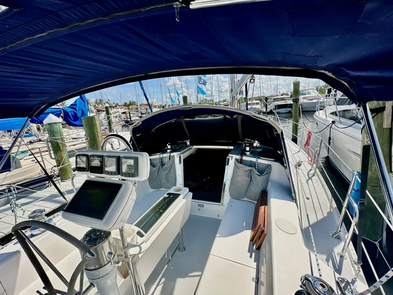 Slide: The Image of 2005 Catalina 36 sailboat cockpit with navigation equipment, docked at a marina under a blue canopy. - 38