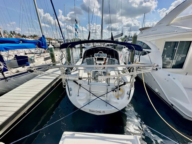 Slide: The Image of Catalina 36 sailboat docked at marina, Punta Gorda, Florida, under a partly cloudy sky. - 4
