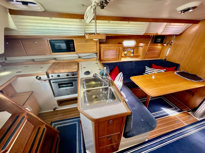 Slide: The Image of Interior of a 2005 Catalina 36 sailboat with kitchen and dining area. - 41