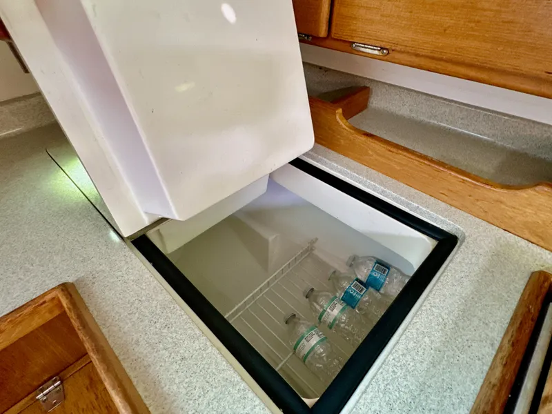 Slide: The Image of Built-in cooler with water bottles in a 2005 Catalina 36 yacht kitchen. - 43