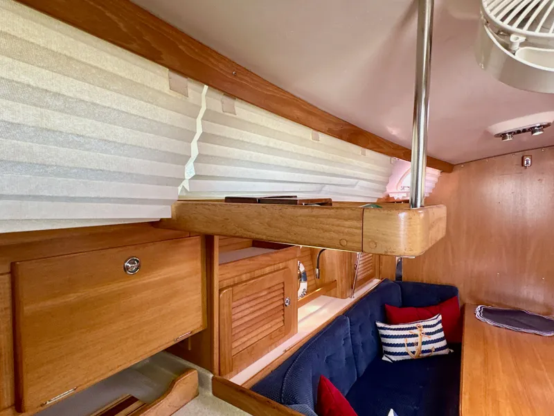 Slide: The Image of Interior of 2005 Catalina 36 sailboat with wooden cabinets and cozy seating area. - 45