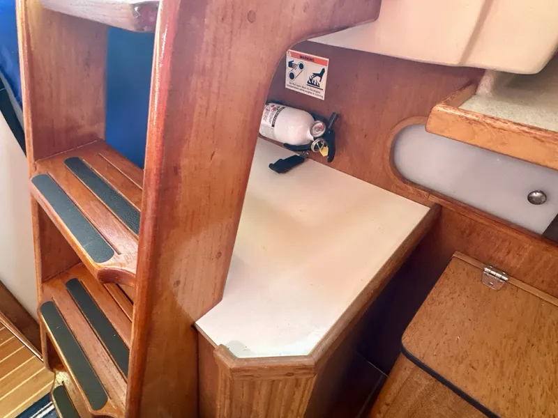Slide: The Image of Interior of 2005 Catalina 36 sailboat with wooden steps and fire extinguisher. - 49