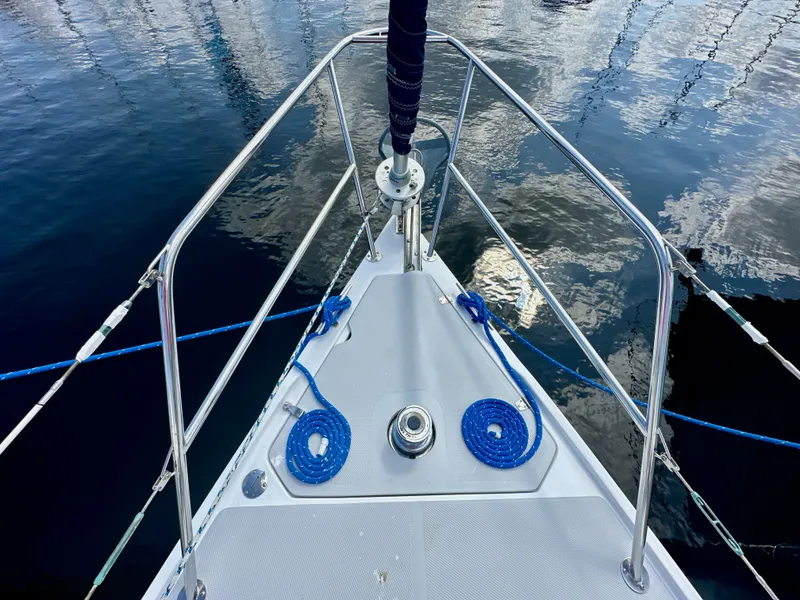 Slide: The Image of Bow of 2005 Catalina 36 sailboat with blue ropes and calm water reflection. - 6