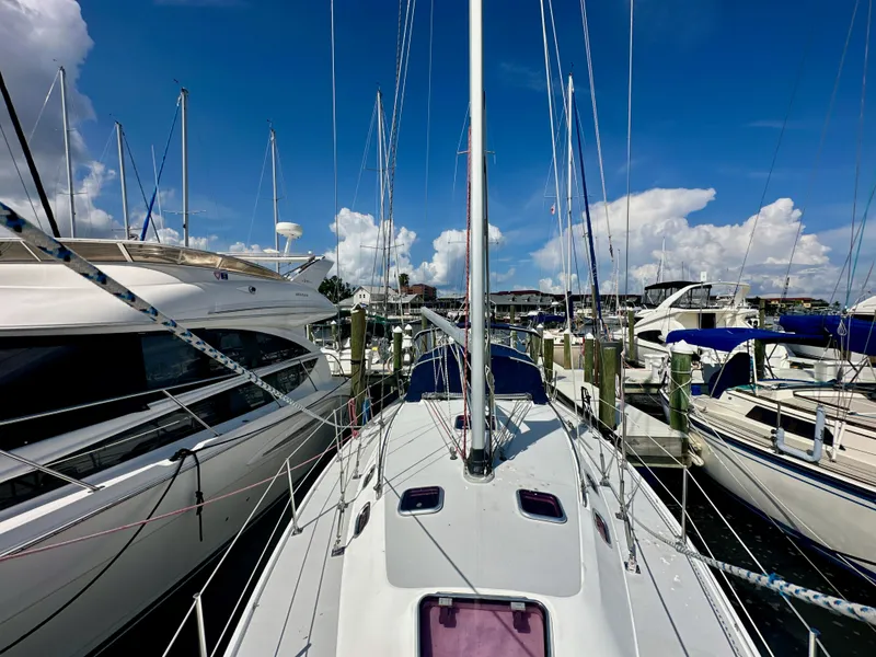 Slide: The Image of Catalina 36 sailboat docked at marina, surrounded by other boats under a clear blue sky. - 9
