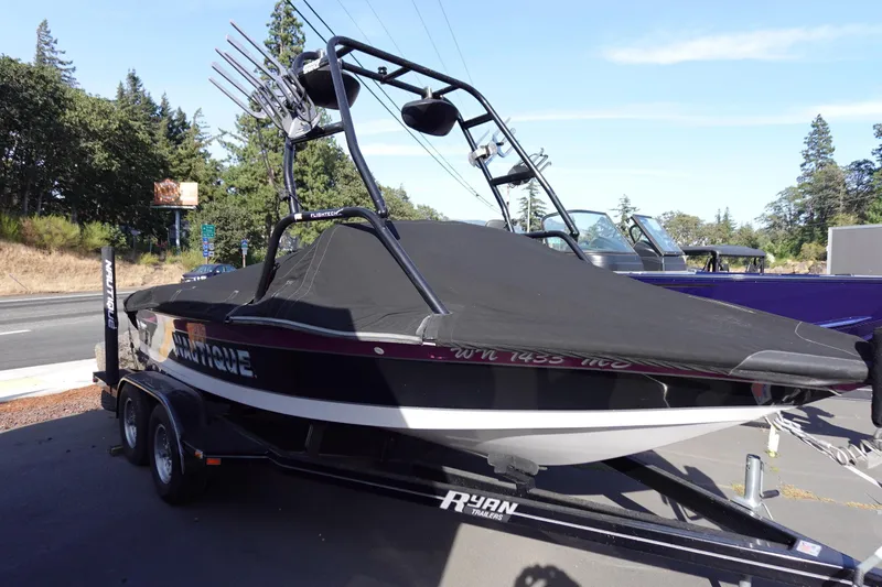 Slide: The Image of 1993 Correct Craft Ski Nautique 200 Closed Bow boat on trailer, covered and parked outdoors. - 10