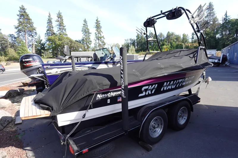 Slide: The Image of 1993 Correct Craft Ski Nautique 200 Closed Bow boat on trailer, covered and parked outdoors. - 11