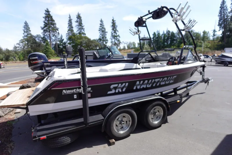 Slide: The Image of 1993 Correct Craft Ski Nautique 200 Closed Bow boat on trailer, parked outdoors. - 2
