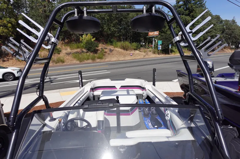 Slide: The Image of 1993 Correct Craft Ski Nautique 200 boat with wakeboard tower, parked roadside. - 21