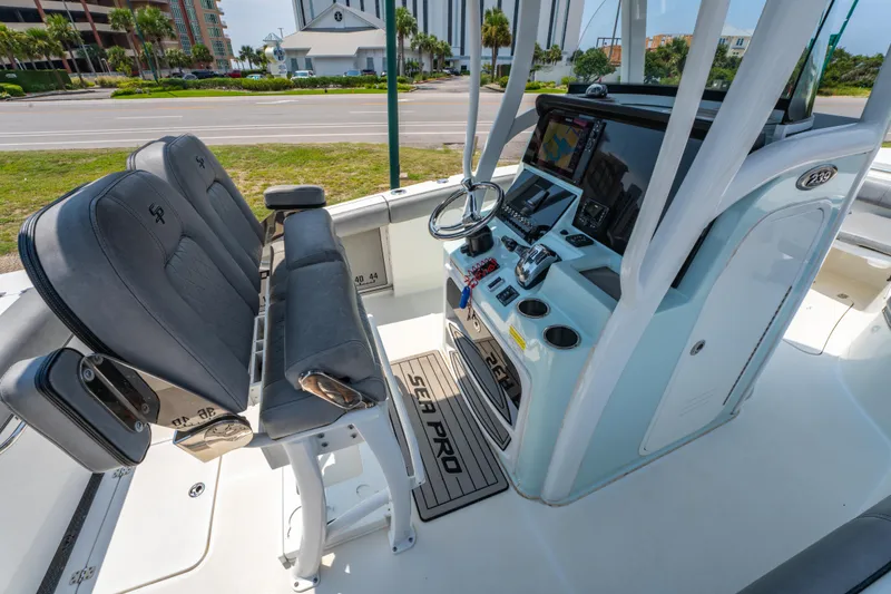 Slide: The Image of 2021 Sea Pro 239 Center Console boat interior with helm and seating. - 14