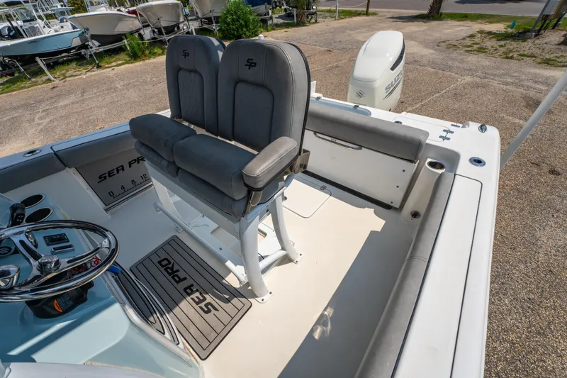 Slide: The Image of 2021 Sea Pro 239 Center Console boat interior with seating and steering wheel. - 15