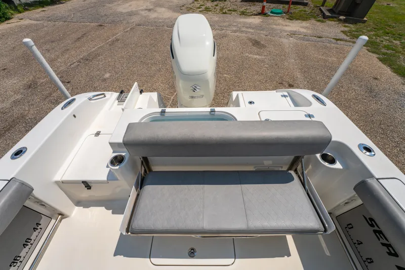 Slide: The Image of 2021 Sea Pro 239 Center Console boat with cushioned seating and Suzuki outboard motor. - 16