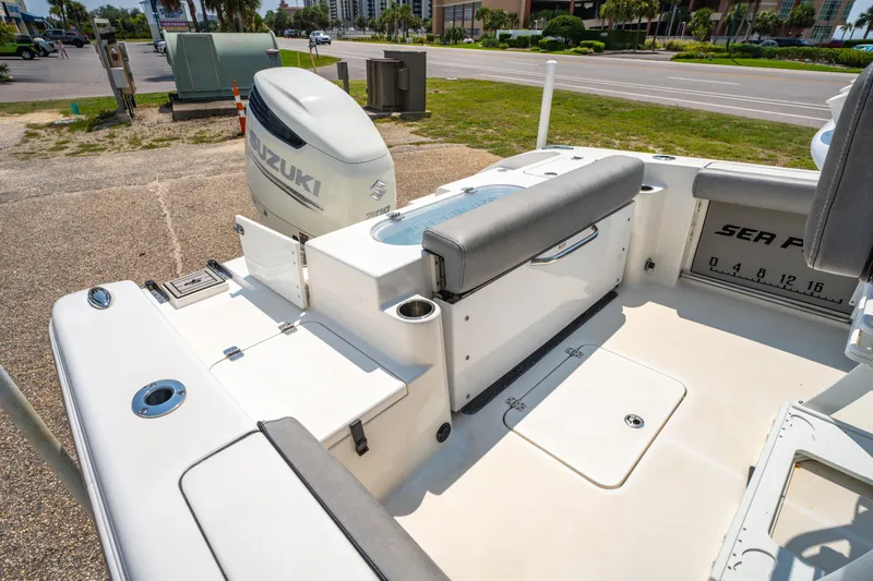 Slide: The Image of 2021 Sea Pro 239 Center Console boat with Suzuki outboard motor, docked on a sunny day. - 17