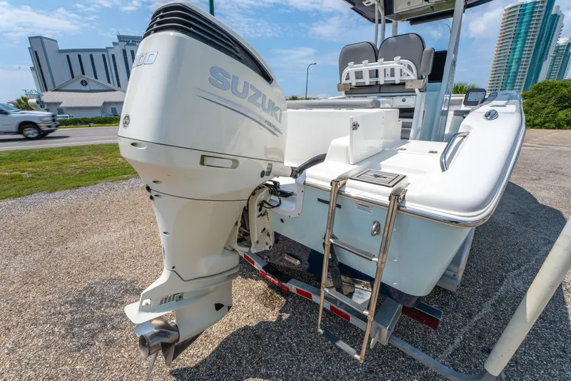 Slide: The Image of 2021 Sea Pro 239 Center Console boat with Suzuki outboard motor, parked on gravel. - 18