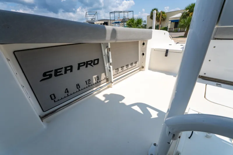 Slide: The Image of 2021 Sea Pro 239 Center Console boat interior with measurement markings and storage. - 19
