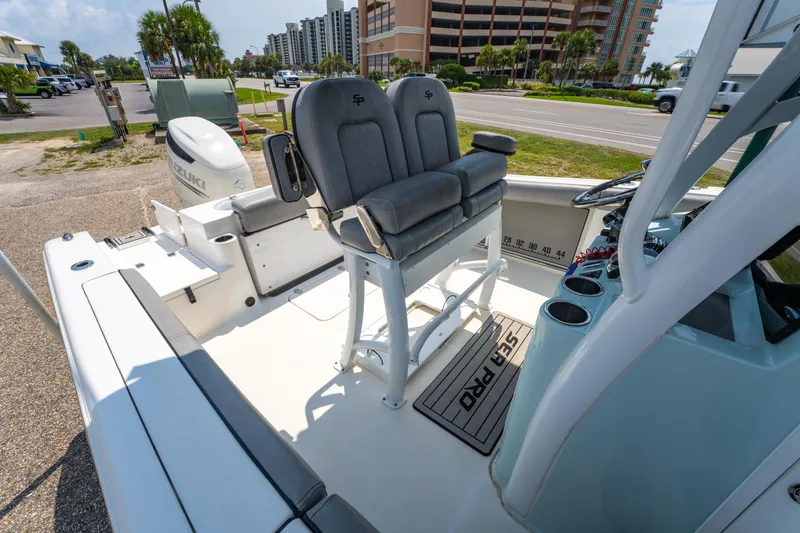 Slide: The Image of 2021 Sea Pro 239 Center Console boat with Suzuki engine, docked near coastal buildings. - 20