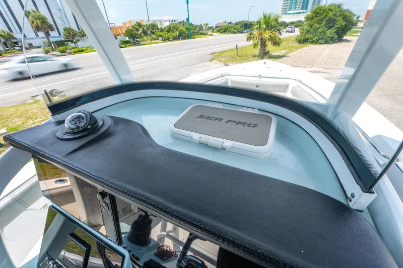 Slide: The Image of 2021 Sea Pro 239 Center Console boat dashboard with compass and storage compartment. - 24
