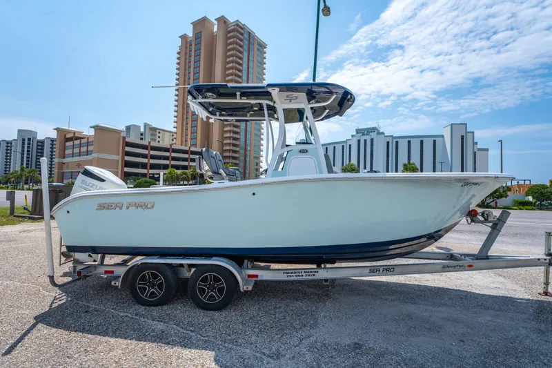 Slide: The Image of 2021 Sea Pro 239 Center Console boat on trailer, urban background, clear sky. - 3