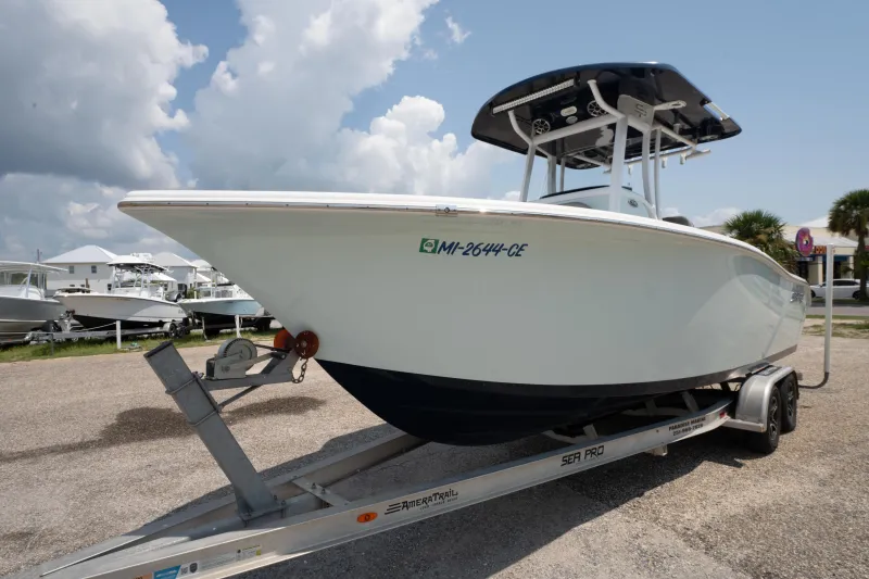 Slide: The Image of 2021 Sea Pro 239 Center Console boat on trailer, parked outdoors under cloudy sky. - 6