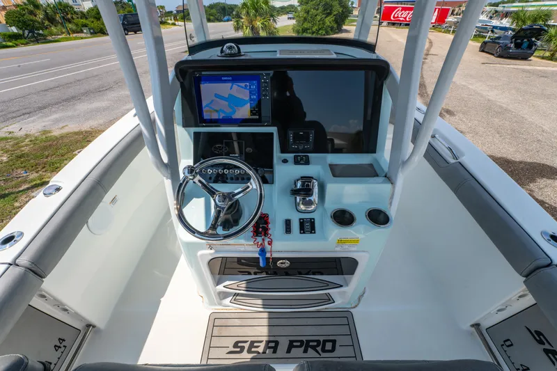 Slide: The Image of 2021 Sea Pro 239 Center Console boat dashboard with steering wheel and navigation display. - 9
