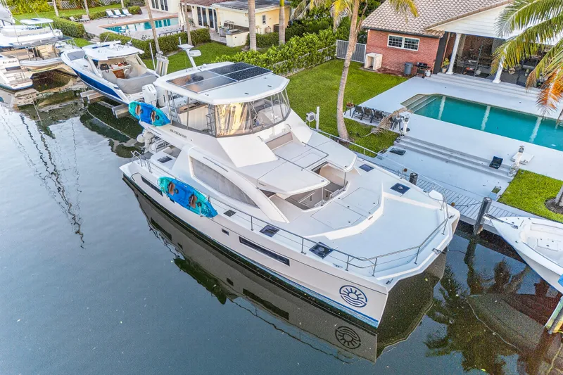 Slide: The Image of 2018 Leopard 51 Powercat yacht docked by a waterfront home with pool. - 106