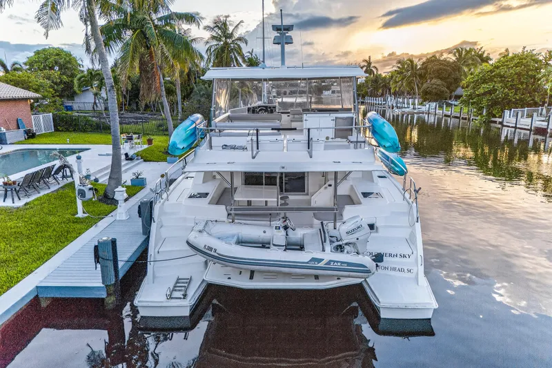 Slide: The Image of 2018 Leopard 51 Powercat yacht docked by a tropical waterfront at sunset. - 108