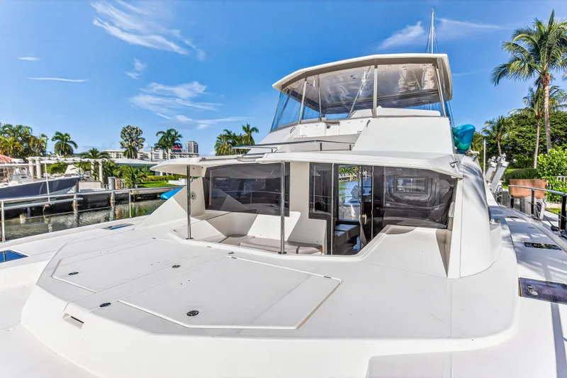 Slide: The Image of 2018 Leopard 51 Powercat yacht docked, featuring spacious deck and modern design. - 11