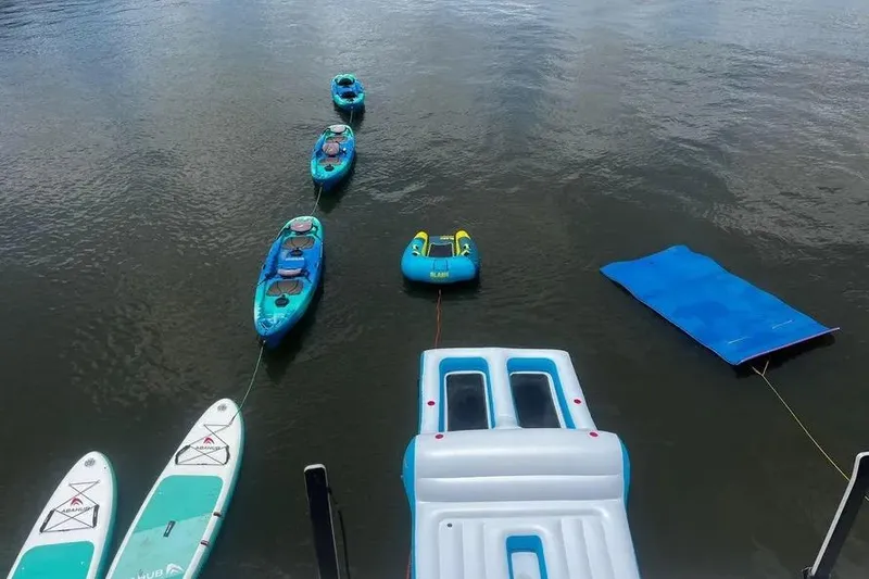 Slide: The Image of Inflatable water toys and kayaks floating near a Leopard 51 Powercat, 2018 model. - 111