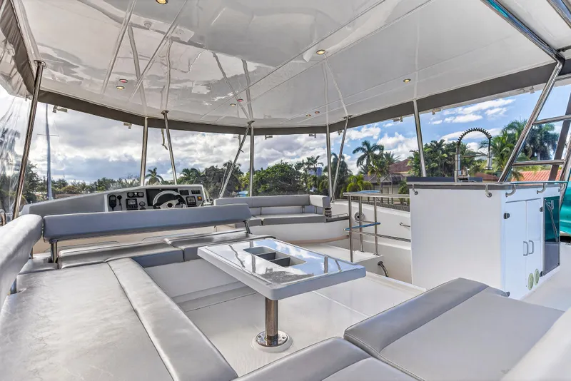 Slide: The Image of 2018 Leopard 51 Powercat interior with modern seating and outdoor views. - 16