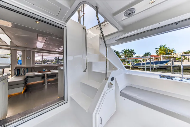 Slide: The Image of 2018 Leopard 51 Powercat interior with modern seating and sleek staircase design. - 19