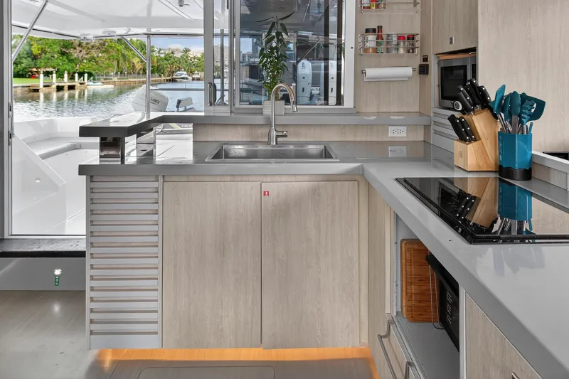 Slide: The Image of Modern kitchen interior on 2018 Leopard 51 Powercat yacht, featuring sleek countertops and appliances. - 21