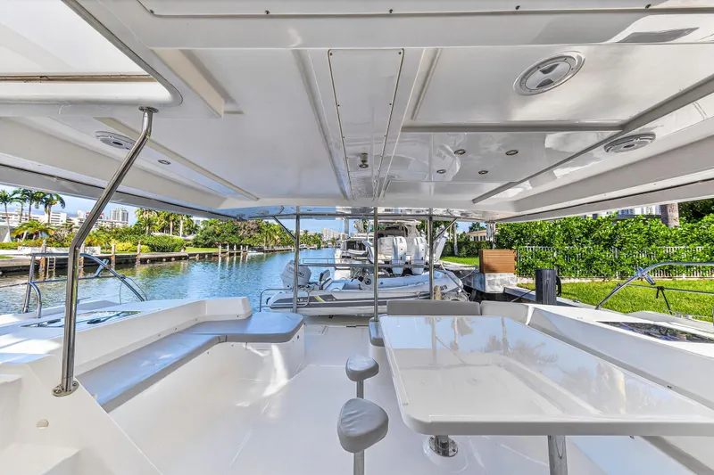 Slide: The Image of 2018 Leopard 51 Powercat yacht interior with spacious seating and scenic waterway view. - 32