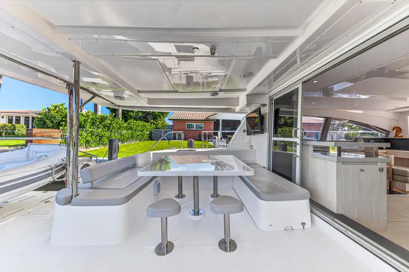 Slide: The Image of 2018 Leopard 51 Powercat yacht with outdoor seating and dining area. - 34